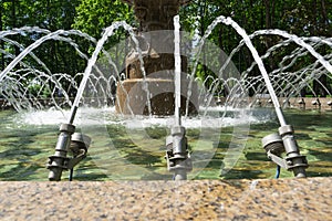 Fountain in the summer park, water jets close-up