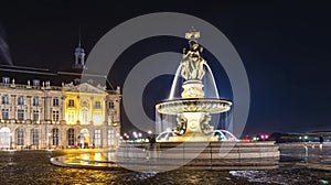 Fountain of three graces and building of the chamber of commerce, on the Place de la Bourse in Bordeaux, at night in Gironde, New
