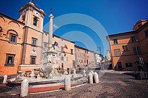 Fountain and town hall in the square of Tarquinia Italy