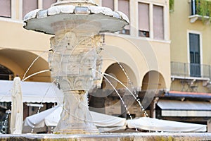 Fountain Verona with Palazzo Maffei and Gardello tower at the background on Piazza delle Erbe in Verona, Italy.