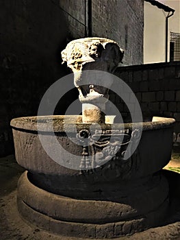 Fountain in Viterbo city, near Rome, Italy. Light and darkness, stone and water
