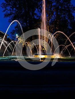 Fountain with water jets and lights at night