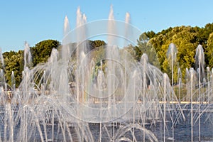 Fountain with water spurting up different streams. Multi-colored rainbow in the fountain.