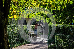 18.09 071. Fountains of Peterhof. The girl puts her hands under the stream of water. St. Petersburg.