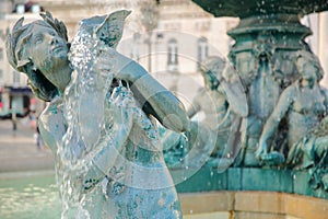 Fountains in Rossio Square, close-up on one of the mermaid statues in Baixa neighborhood, Lisbon, Portugal