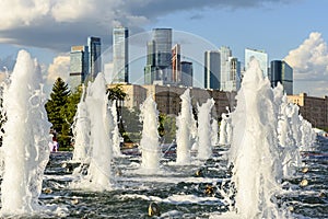 Fountains in Victory park on Poklonnaya hill with Moscow city at background, Russia