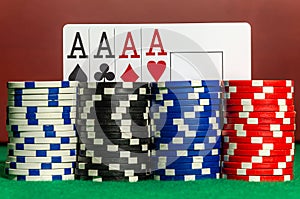 Four ace cards on the background of poker chips in a casino