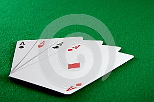 Four aces on card table