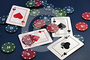 Four aces and chips, card game, cards on the table. Poker and blackjack