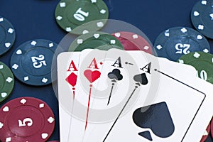 Four aces and chips, card game, cards on the table. Poker and blackjack