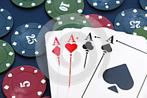 Four aces and chips, card game, cards on the table. Poker and blackjack