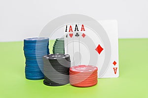 Four aces between chips on a white background