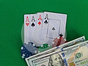 Four of aces in a deck of playing cards and chips for playing poker