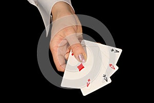 Four aces in female hand on black
