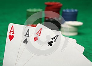 Four aces with gambling chips