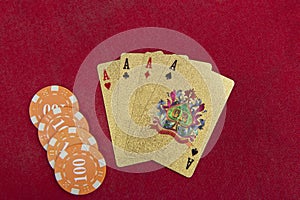 Four aces near stacks of chips on a red felt table