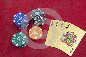 Four aces near stacks of chips on a red felt table