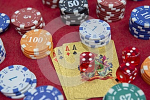 Four of aces near stacks of chips on a red felt table