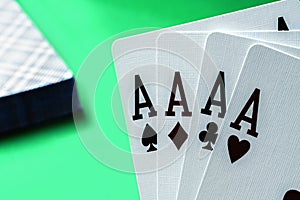 Four aces poker cards against green background. Four of a kind combination in poker game. Poker combinations concept. Horizontal