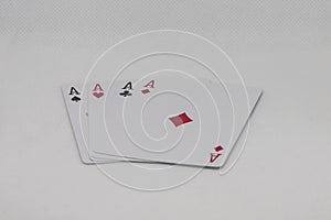 Four aces poker cards stacked side by side