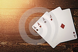 Four aces on wooden surface. Concepts of gambling and luck