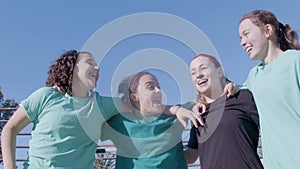 Four active teenaged girls cheering up and jumping with joy