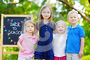Four adorable little kids are going back to school