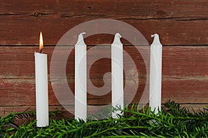 Four advent candles at an old plank wall