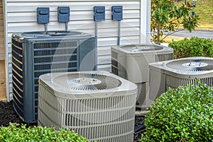 Four Air Conditioning Units Outside Of An Upscale Apartment Complex