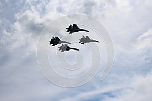 Four aircraft combat fighters a great strong powerful SU-34 military fighters flying in the sky