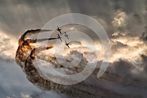 Four airplanes formation on a sunset sky at an air show