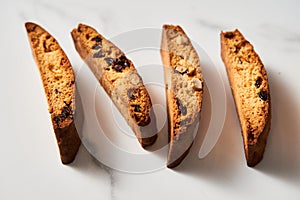 Four Almond and Cranberry Biscotti Standing on Edge, Marble Countertop with Soft Shadow Detail