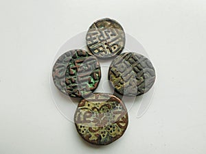 Four ancient coins on white background