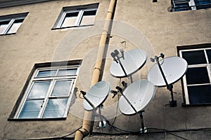 Four antennas on the beige wall