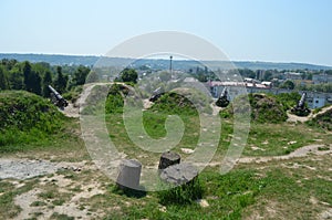 Four antique cannons stand on the hill.