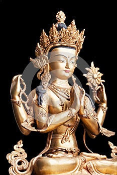 Four-armed form of Avalokiteshvara made of metal isolated on black background