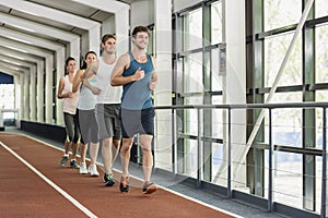 Four athletic women and men stretching