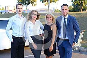 Four attractive modern young people, two boys and two girls smil