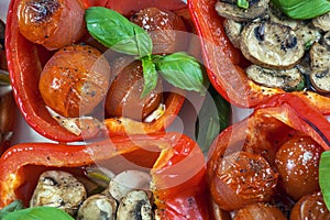 Four baked peppers with basil, cherry and champignons