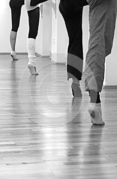 Four ballerinas standing on one feet