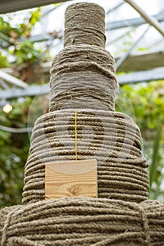 Four big hasps of Rough Cord made from natural plant flax fiber with mockup lable. Rope detail, closeup. Vertical