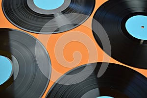 Four black vinyl record on orange