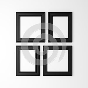 Four blank black photo frames on wall