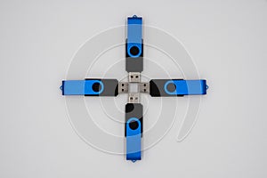 Four blue black USB sticks in a formation on a white background
