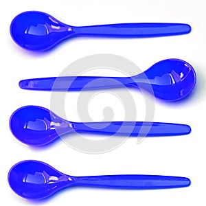 Four blue plastic teaspoons, one against the mainstream