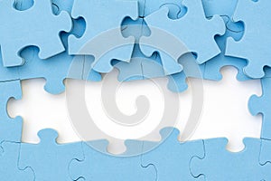 Four blue puzzle pieces revealing white background