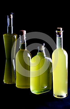 Four bottles of sorrento limoncello , black backround