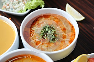Four Bowls of Soup With Garnishes on a Table