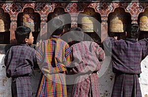 Four boys in traditional dress, called gho