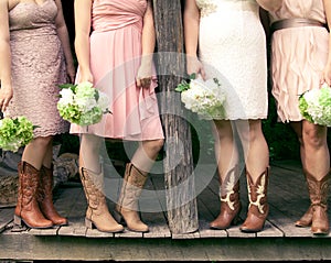 Bridesmaids in cowboy boots on a rustic porch